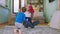 Yoga time at home in the living room on the floor dad with his two small kids practicing yoga poses the big boy showing