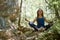 Yoga time or Meditation. Contemplation. Lady meditates on nature. Full relaxation. Pensive mood. Green forest.