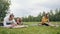 Yoga training in park - young sportsmen performs flexibility exercise outdoor