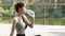 Yoga training, teenager girl in the park is sitting in the lotus position, a girl in nature, health outdoor