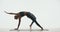 Yoga tutorial video. Female fitness instructor graceful perform Wild Thing Pose Camatkarasana on white studio background