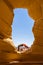 Yoga in the wilderness, back bend under arch inside a window overlooking the Arizona desert