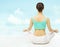 Yoga woman back view meditate sitting in lotus pose over sky background.