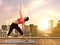 Yoga woman doing poses on city rooftop