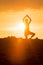 Yoga Woman doing yoga pose outside in sunset