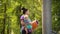 Yoga woman going to outdoor training with baby in sling