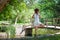 Yoga woman instructor practice yoga outdoor in park by the pond