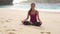 Yoga woman. Lotus pose on beach