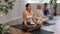 Yoga woman making yoga meditation in lotus pose in modern fitness studio
