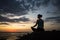 Yoga woman meditating on the ocean coast at dusk. Sport.