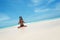 Yoga woman meditating at serene tropical beach, morning zen mediation