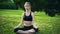 Yoga by woman meditation in lotus position in park outdoor