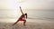 Yoga woman pose at beach doing doing Extended Side Angle Yoga Pose