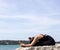 Yoga woman poses on beach near sea and rocks