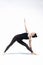 Yoga Woman On A White Background Practicing Triangle Pose