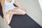 Yoga woman in white clothes meditates calm sitting in lotus position in room.