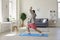 Yoga work at home. Funny fat man practices yoga meditation while sitting on the floor in the room online at home.