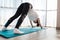 Yoga. A young woman doing a stretching exercise. Adho Mukha Shvanasana. Rear view. The concept of home workouts