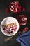 Yoghurt with cereals and fresh forest fruits and sliced pomegranate.