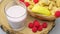 Yoghurt in a glass, fruit basket and fruit yoghurt, raspberries with dairy products