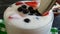 Yoghurt gourmet cheese raspberry strawberry blueberry spoon slow motion