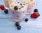 Yoghurt, oatmeal blueberry strawberry delicious on a blue wooden background