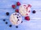 Yoghurt, oatmeal blueberry strawberry healthy delicious on a blue wooden background