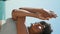 Yogi girl crossing hands in front face training on Ursa beach vertical close up