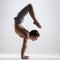 Yogi man in yoga Scorpion Pose, side view