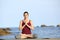 Yogi practicing yoga pose on the beach