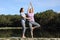 Yogi teaching yoga to a woman in a lake