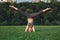 Yogi woman doing stretching workout in park outdoors at sunset.