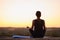 Yogi woman sit at mat in sunrise