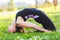 Yogini girl bending body on yoga mat in sunny park early in the morning