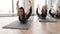 Yoginis doing Bow Pose on mats in fitness centre