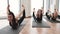 Yoginis doing Bow Pose on mats in fitness centre