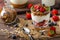 Yogurt with baked granola and berries in small glass