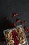 Yogurt, cereal bran sticks and pomegranate seeds in tray with dried fruits