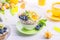 Yogurt with chia seeds, corn pads, kiwi, blueberries, physalis and mint on a background