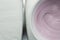 Yogurt close up view form top - Natural rasberry flavored yoghurt in white bowl on wood table