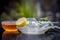 Yogurt face pack with raw lemon juice,honey and turmeric powder and yogurt or curd in a glass bowl on wooden surface,Close up view