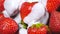 Yogurt falling on fresh strawberries