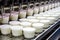 yogurt-filled cups moving on a conveyor line