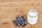 Yogurt in glass jar and blueberries on a wooden background - mock up template