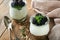 Yogurt with granola, blackberry berry fruits and muesli served in glass jar on wooden background. Healthy breakfast concept. Healt