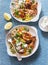 Yogurt marinated grilled chicken breast and israeli couscous and vegetables tabouli salad on a blue background