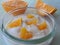 Yogurt with oranges isolated, close up.