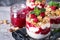 Yogurt parfafait with granola and raspberries in glass.