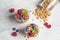 Yogurt parfait with granola, raspberries and blueberries in glasses, copy space, top view. Healthy breakfast concept