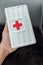 Yogyakarta, Indonesia - December 31, 2021:Close-up of hands holding first aid kit with red cross symbol in car